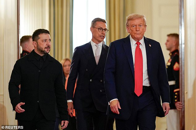 Trump and Ukrainian President Volodymyr Zelenskiy walk during a meeting on Monday