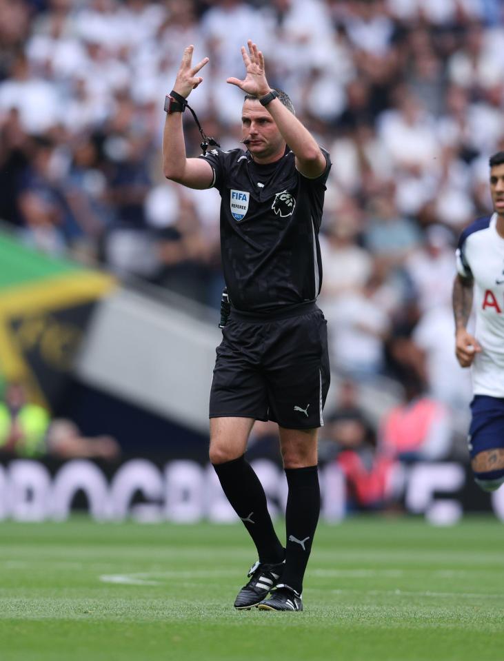 Referee signaling a corner kick during a soccer match.