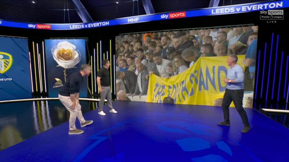 Gary Neville on Sky Sports reacting to a Leeds fan banner.