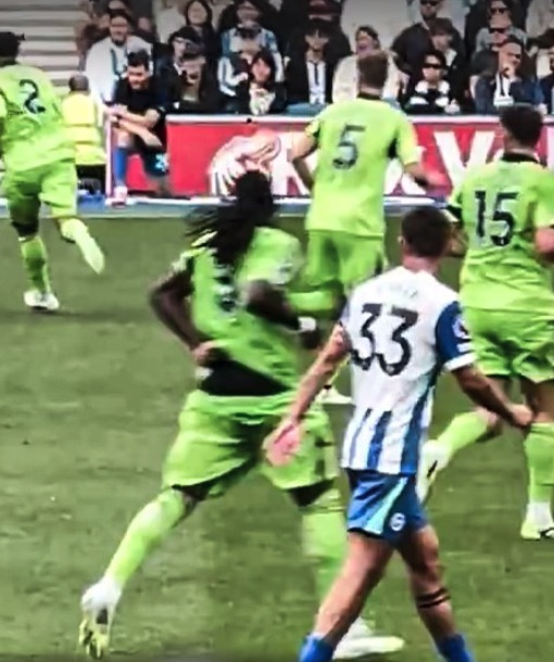 Soccer players in action on a field.