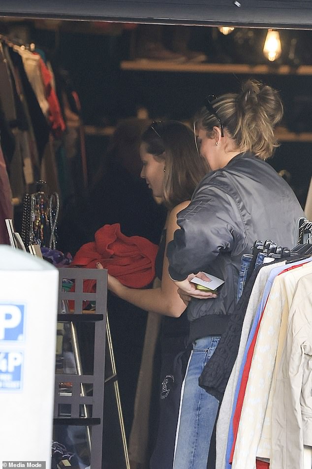 Embracing student life like a local, the thrifty princess was seen sifting through several op shops and picking out some pre-loved pieces, including a cosy-looking red sweatshirt