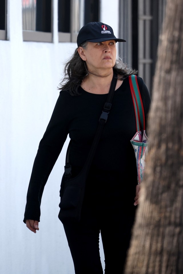 Julia Nickson, actress, walking down the street.