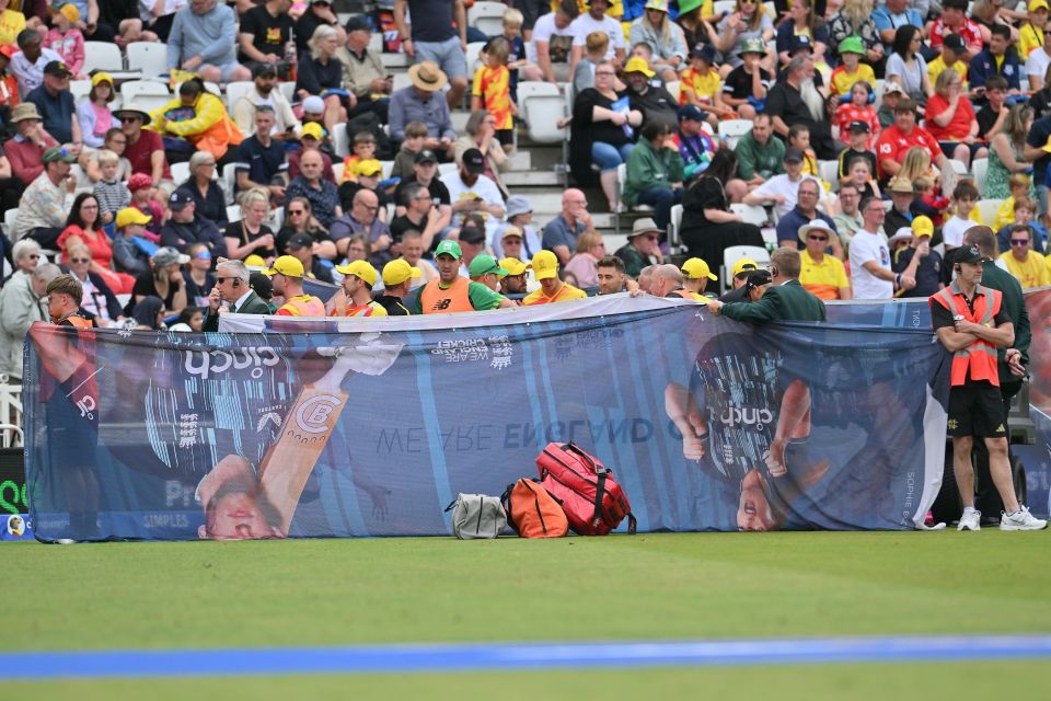 Cricket player receiving treatment behind a screen.