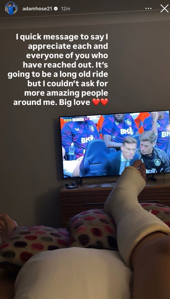 Person with leg in cast watching soccer on TV.