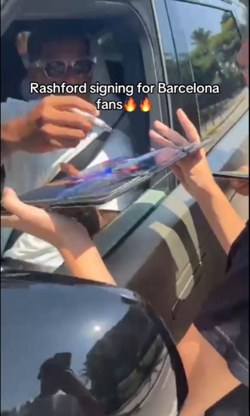 Rashford signing autographs for fans.