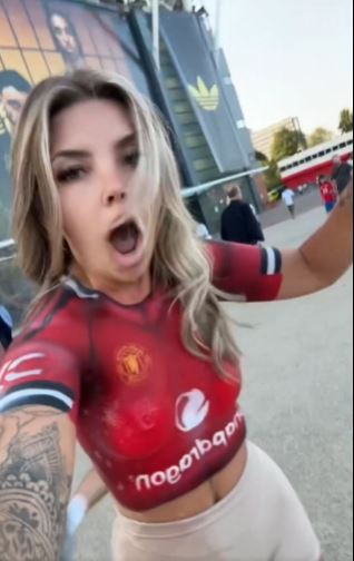 Woman with Manchester United body paint outside Old Trafford.