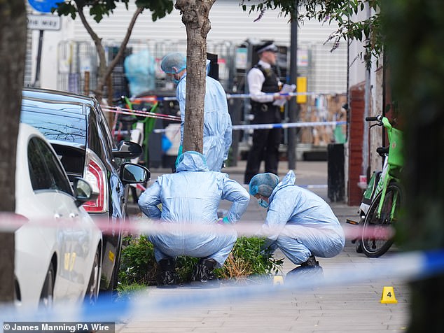 Forensic police officers at the scene of Mr Ozmen's shooting on Dynevor Road in Stoke Newington