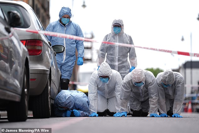 Police forensic officers in Dalston, north-east London, near to the scene of the shooting on Kingsland High Street, Hackney, on May 30