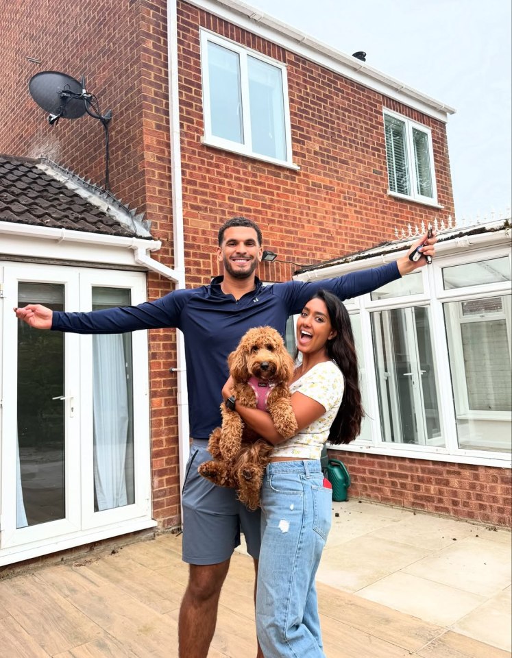 Kai and Sanam, Love Island winners, in front of their new home with their dog.