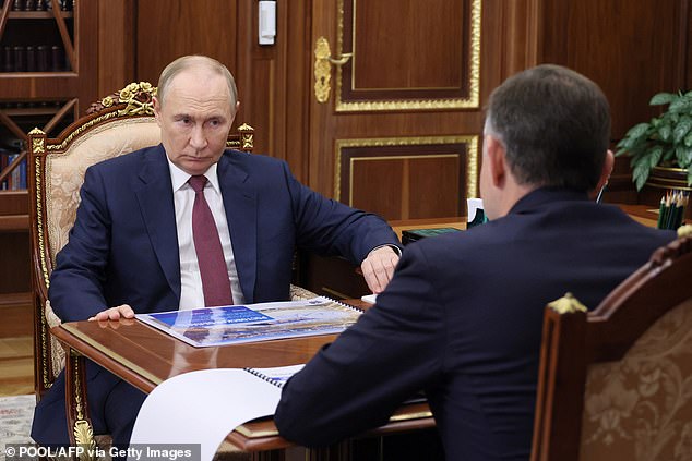 Russia's President Vladimir Putin meets with the acting governor of the Rostov Region Yury Slyusar in Moscow yesterday