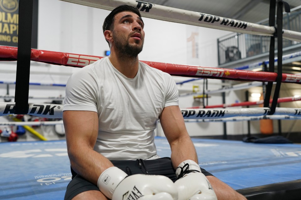 Close-up of Tommy sitting in a boxing ring.