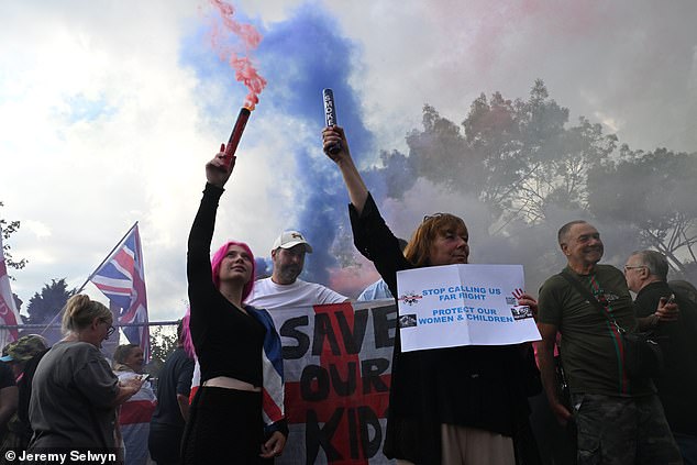 Protesters gather outside the Bell hotel in Epping, Essex, on July 31 to express concern about migrants being housed there