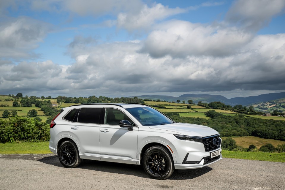 White 2023 Honda CR-V parked in a rural setting.