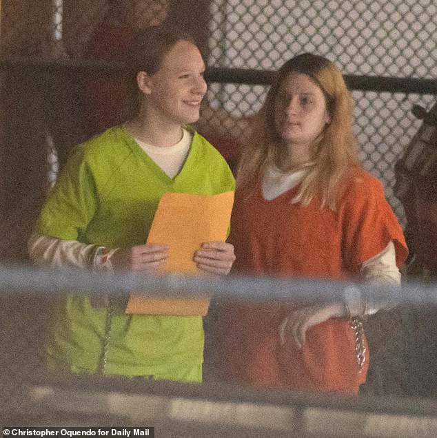 The 17-year-old alleged killer arrived for her bond hearing in a neon green prison jumpsuit and her hair braided as she chatted with a fellow inmate