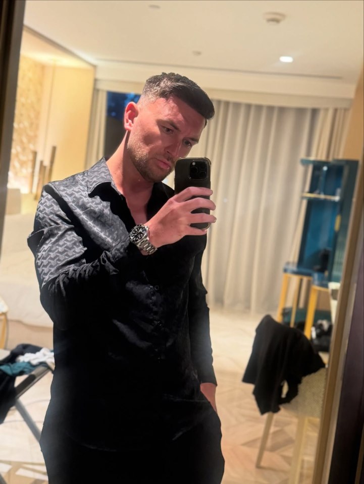 Man taking a selfie in a hotel room.