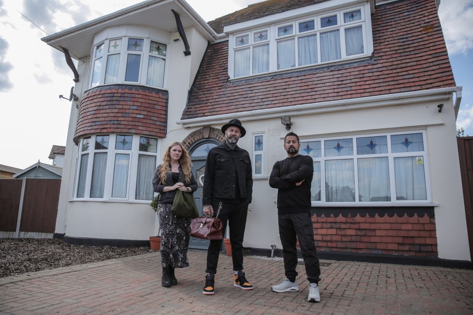 Jayne Harris, Ian Lawman, and Barri Ghai standing in front of a house.