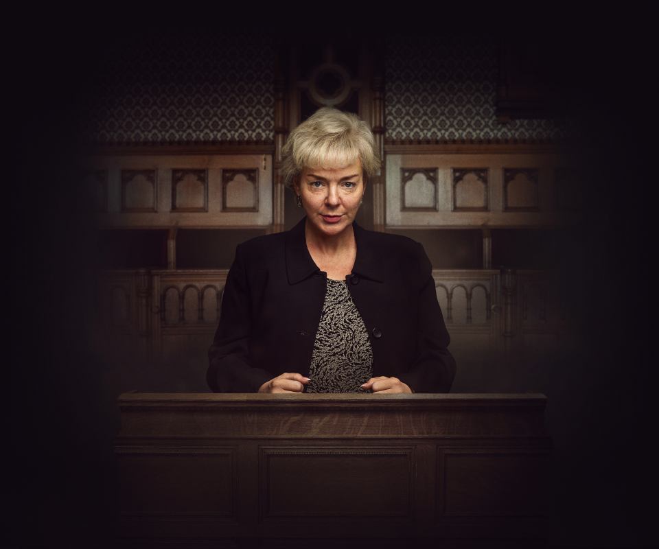 Sheridan Smith behind a wooden lectern.