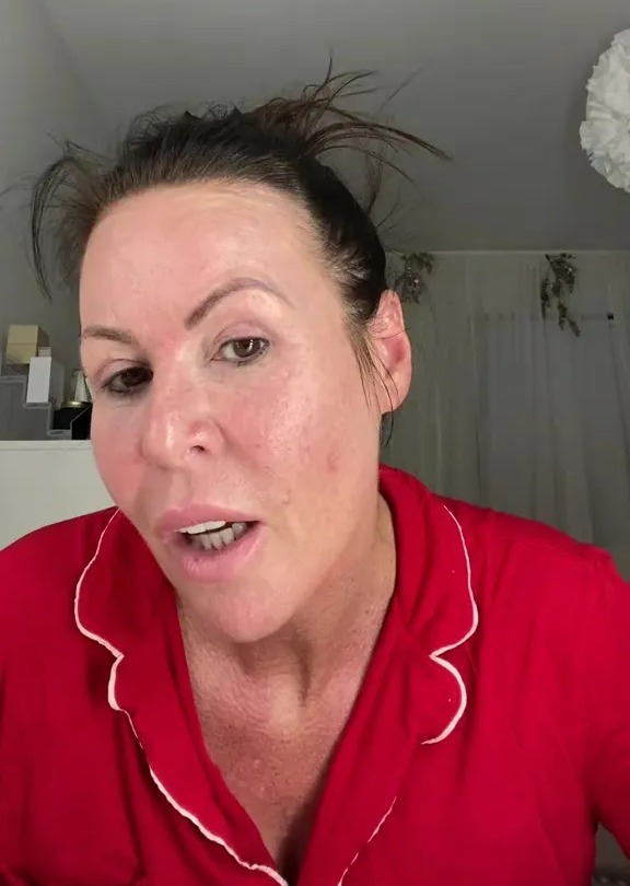 Woman in red pajamas speaking.