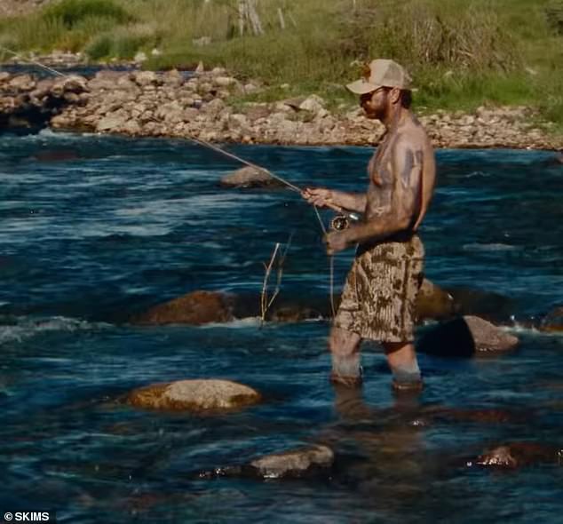 The Cooped Up artist, who appears to be an enthusiastic outdoorsman, took the opportunity to work on his tan while fishing shirtless in a pair of knee-length fleece shorts