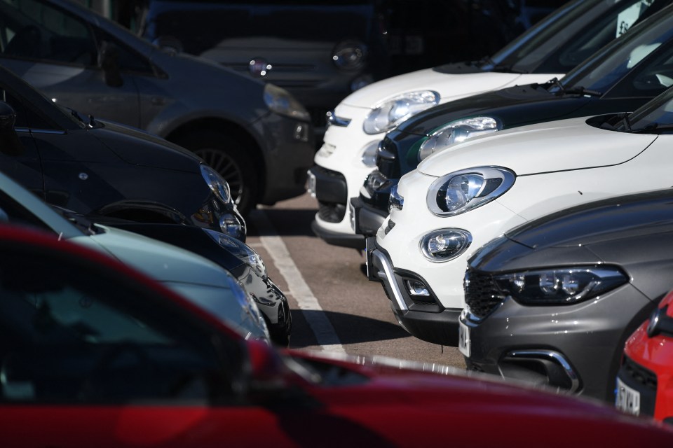 Several cars parked in a row.