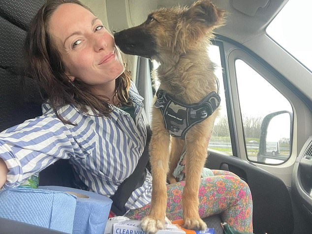 Claire pictured with one of the dogs who was re-homed in the UK after being rescued