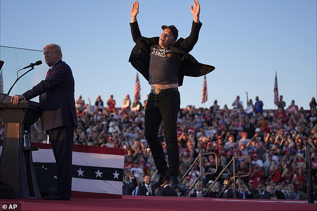 Elon Musk jumps on the stage as Republican presidential nominee former President Donald Trump speaks at a campaign rally at the Butler Farm Show in October of 2024