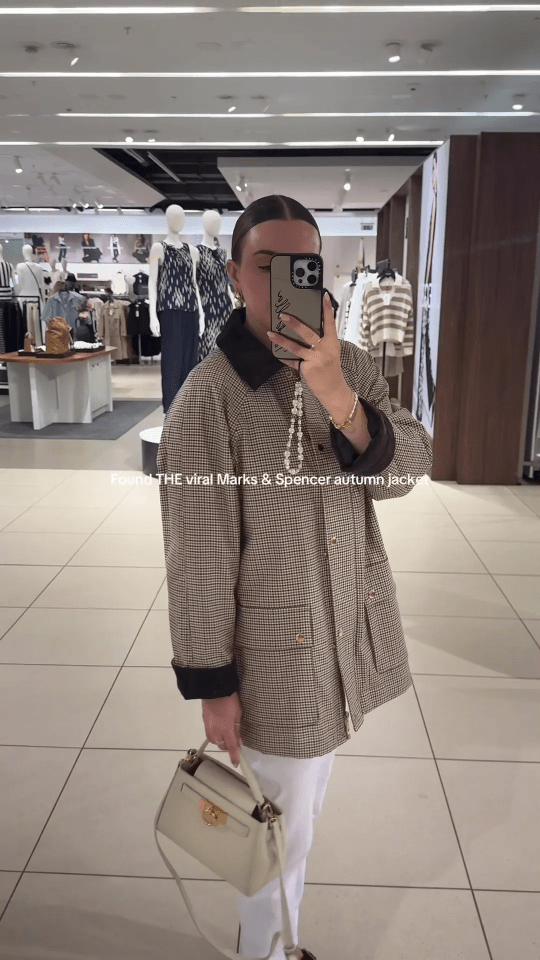 Person in a Marks & Spencer autumn jacket in a store.