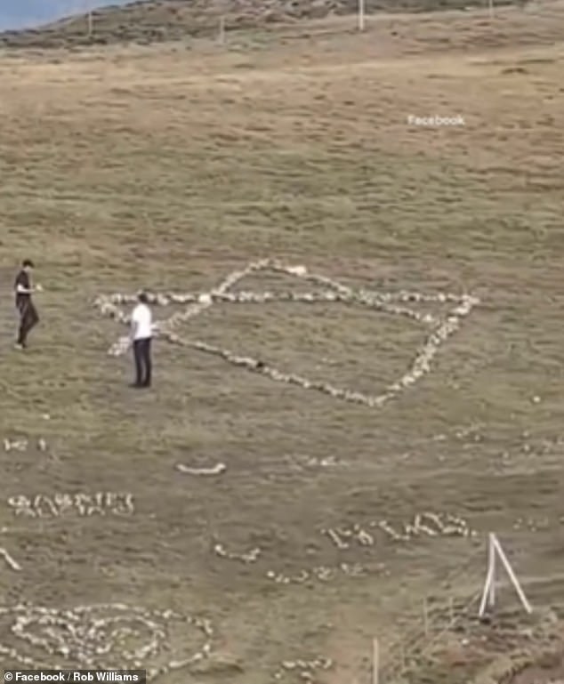 The footage then shows the youngsters using the stones from the cross to make an alternative piece of religious iconography further along the hillside: a Star of David, the symbol of the Jewish faith