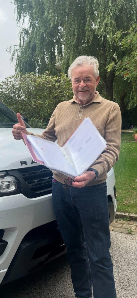 Man holding legal documents and giving thumbs up.