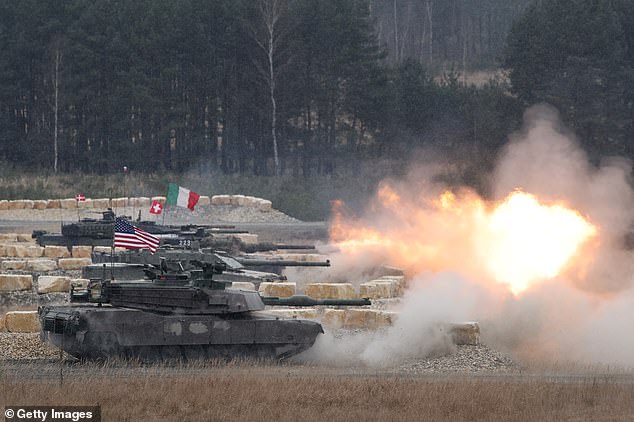 Main battle tanks from different countries, including the United States, Italy, Switzerland and Denmark, fire a volley during the US Army Europe and Africa International Tank Challenge on February 11, 2025 at Grafenwoehr, Germany