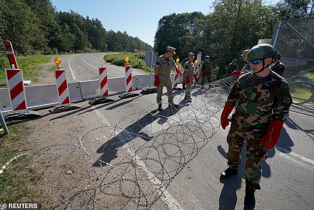 Members of Lithuanian Riflemen's Union instal razor wire on border crossing with Belarus in Sumskas, Lithuania