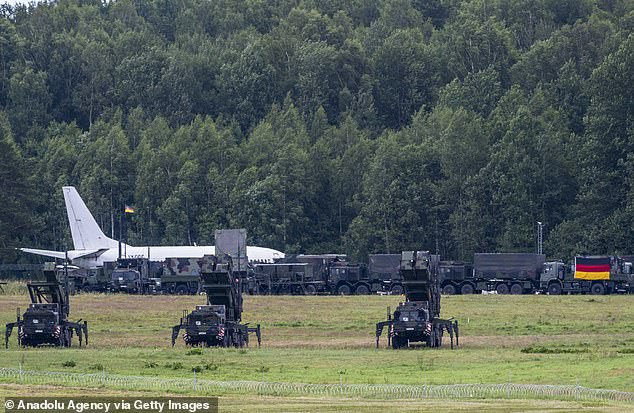 A plane and Germany's Patriot air defense system vehicles are seen ahead of the summit of NATO leaders that is going to take place in Vilnius on June 10, 2023
