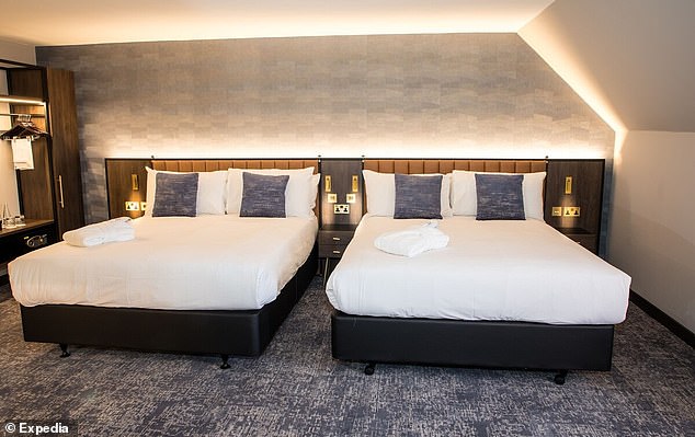Inside the bedroom at the plush hotel near Gatwick. Pictured: A family room with two double beds