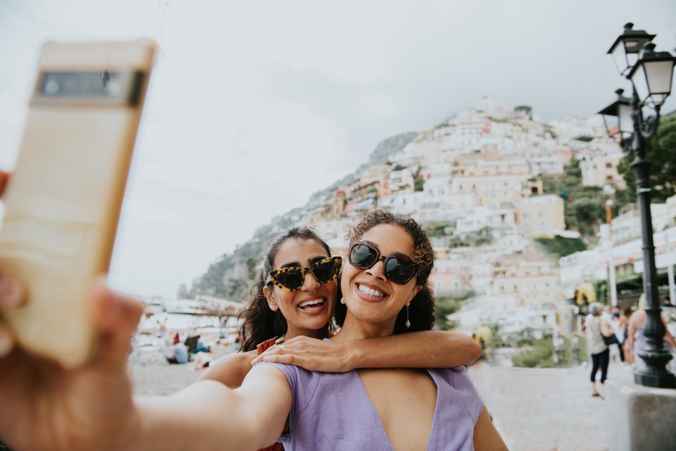 Two women take a selfie in Positano, Italy.