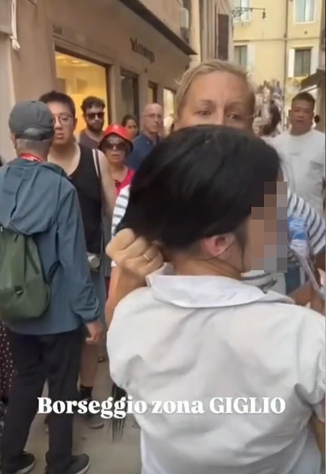 Footage of the incident, which took place on Thursday in the Santa Maria del Giglio area of Venice, shows a furious Christina Cadieu Greene gripping the 14-year-old's hair after spotting the teen sneaking her purse, which contained her money and passport, into her bag