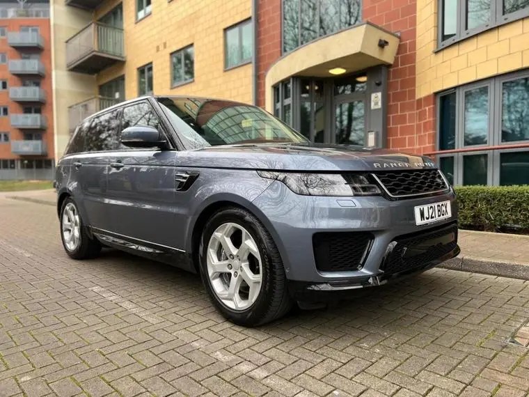 Gray Range Rover parked in front of a building.