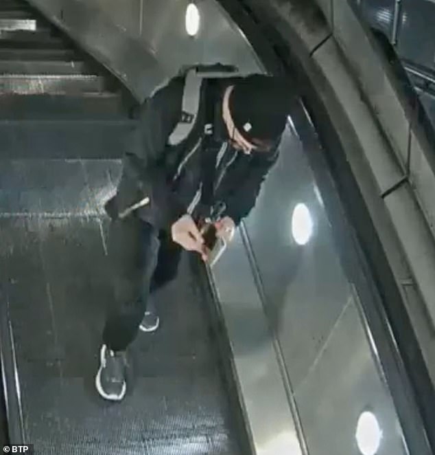 Liam McGuicken, 53, rifles through the wallet he had just stolen from a deaf woman in her 80s