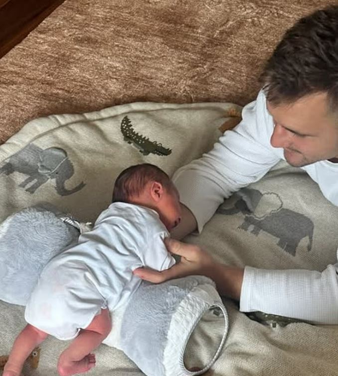 Father holding his newborn baby.
