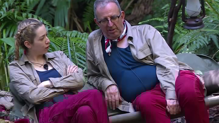 Two I'm A Celeb stars sitting and talking.
