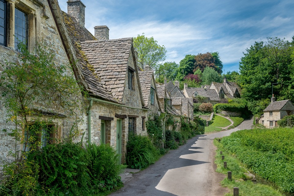 Stone cottages line a country road.