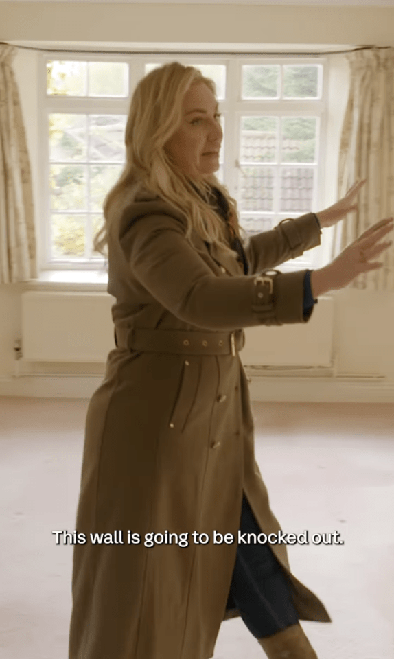 Josie Gibson indicating a wall to be demolished.