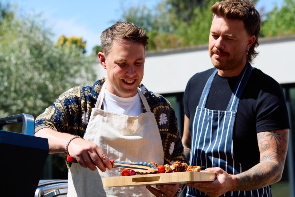 Two men preparing grilled food outdoors.