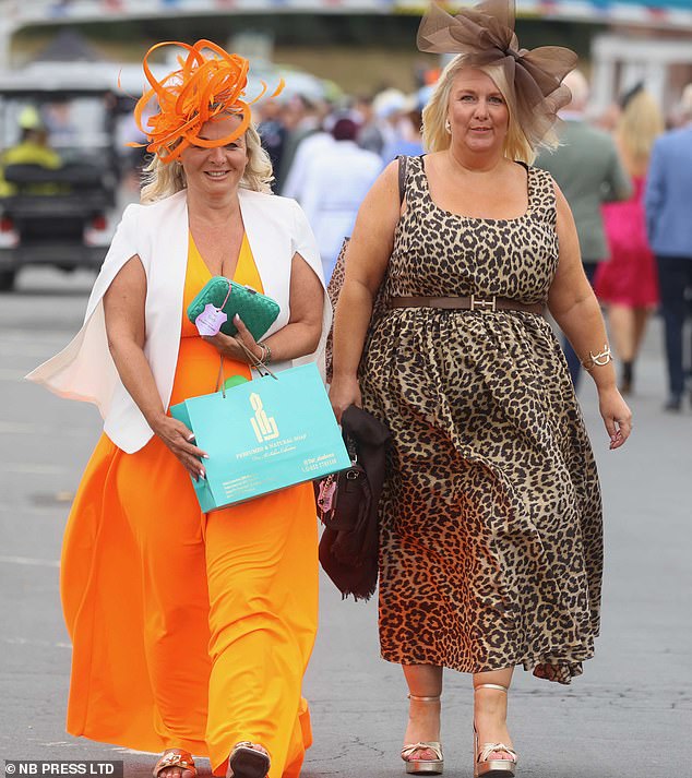 The grey skies in York were no match for the colourful frocks, feathers and fascinators on display for Ladies Day at the race course this afternoon