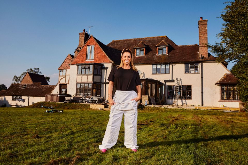Katie Price standing in front of her home.