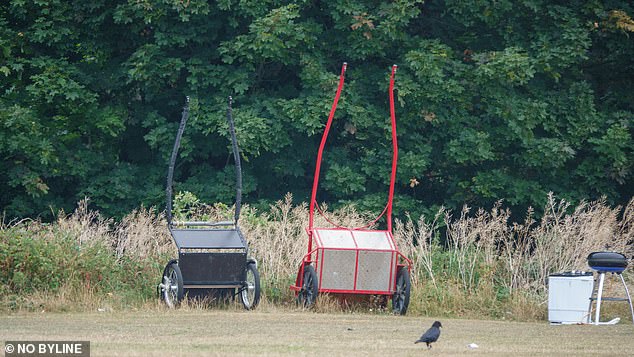 Pictured: wheelbarrows lay abandoned by the unknown group, while a BBQ can also be spotted