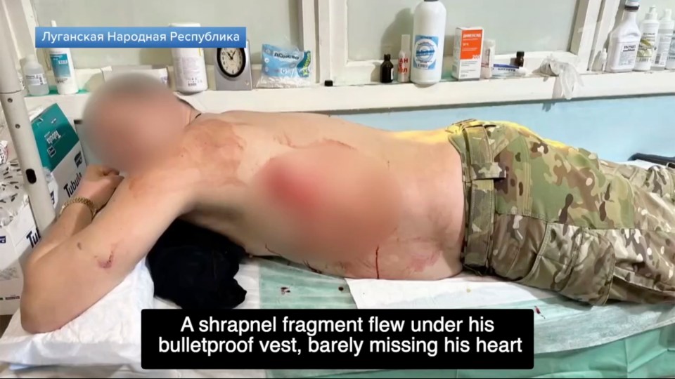 Wounded soldier lying on a medical table.