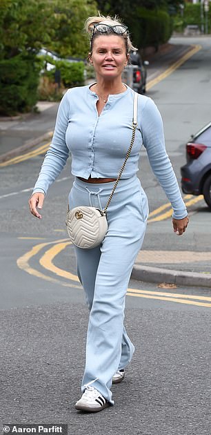 She cut a casual figure in a baby blue cardigan and matching bottoms