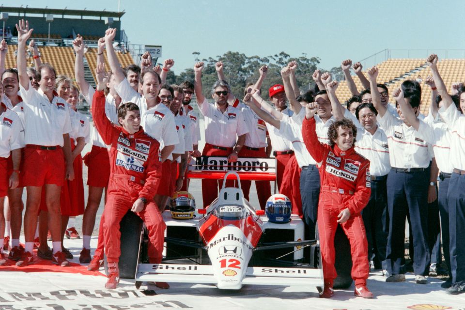 Ayrton Senna and his McLaren Honda team celebrating.