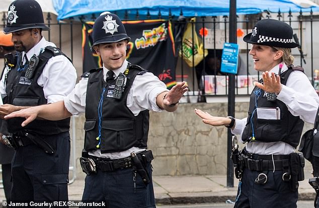 Police show off their dance moves as the Notting Hill Carnival parade passes through in 2015