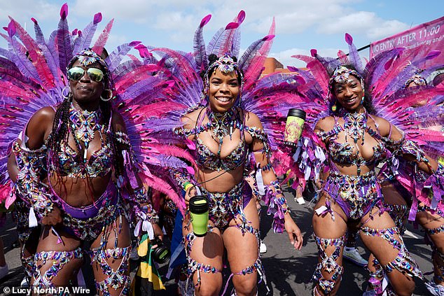 Dancers prepare to take part in the parade at the Notting Hill Carnival in London in August 2024